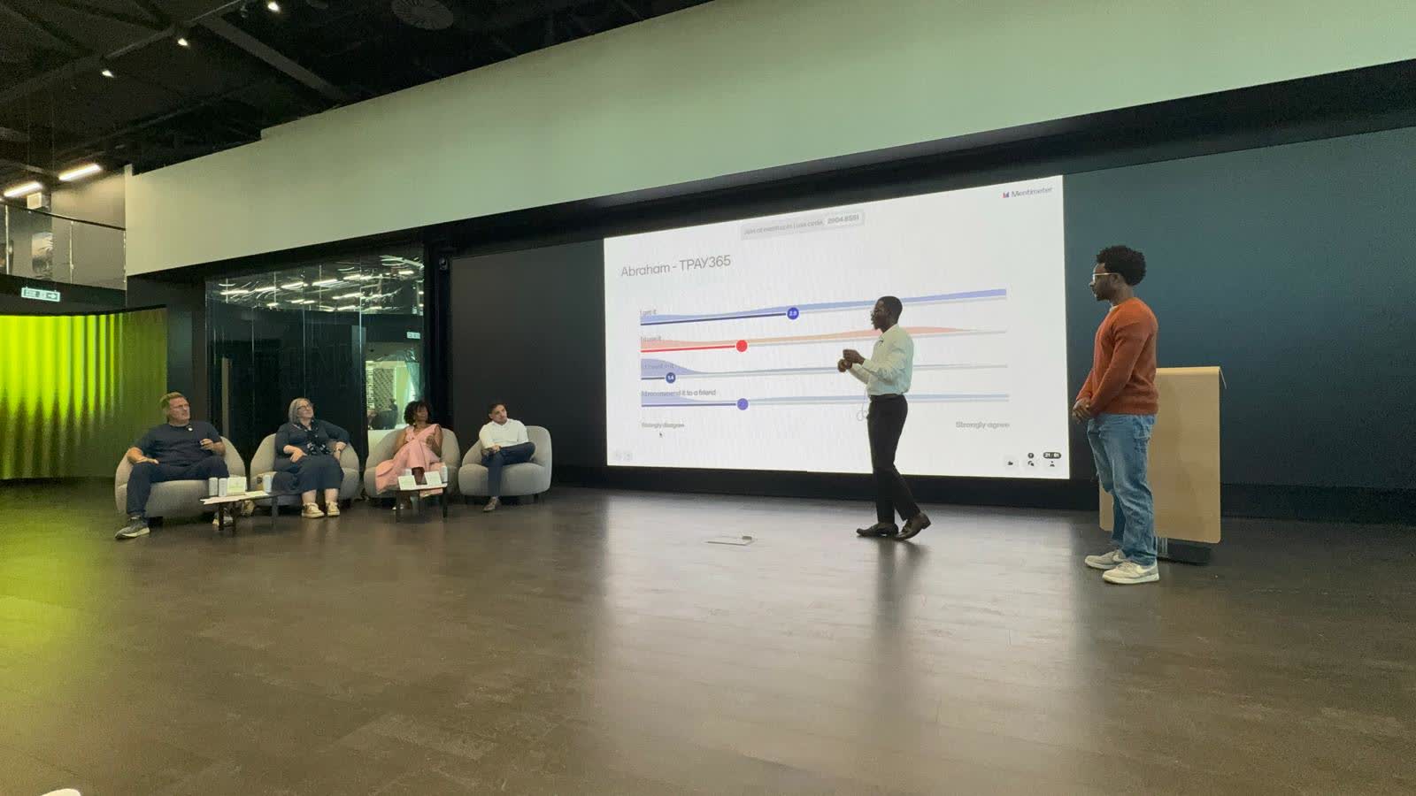 Abraham Orherhe pitching tPay365 on stage at Revolut HQ in London.