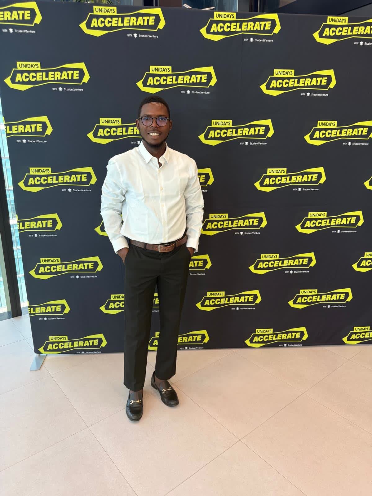 Abraham Orherhe standing in front of the UNiDAYS Accelerate backdrop.
